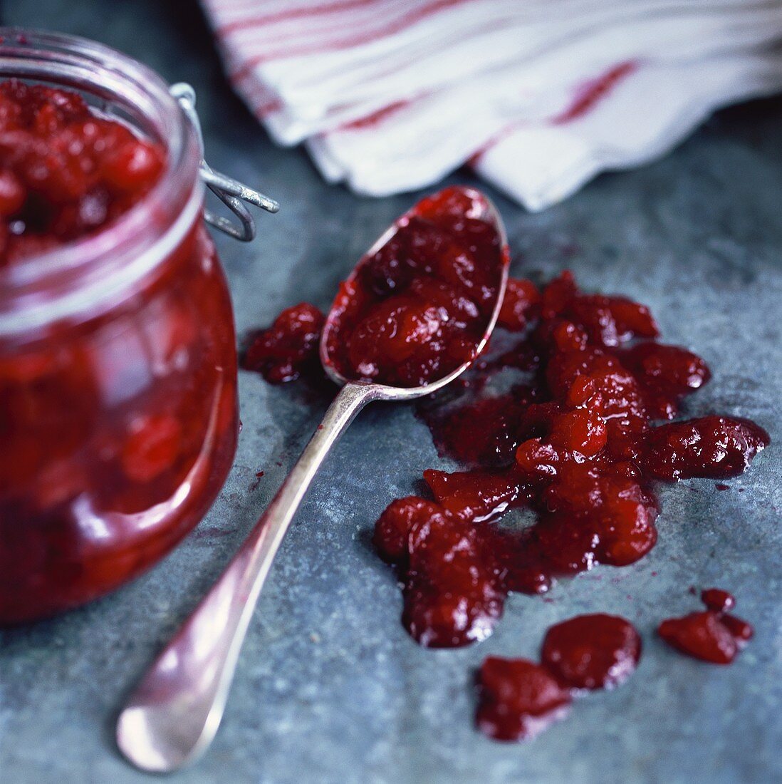 Cranberry relish in preserving jar and on spoon