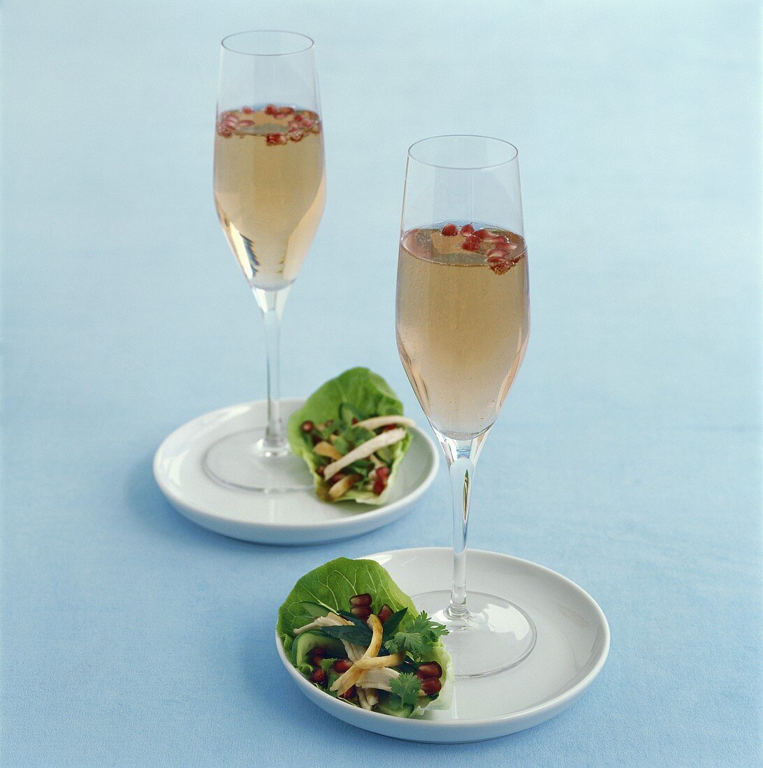 Two pink sparkling wine cocktails and lettuce wraps