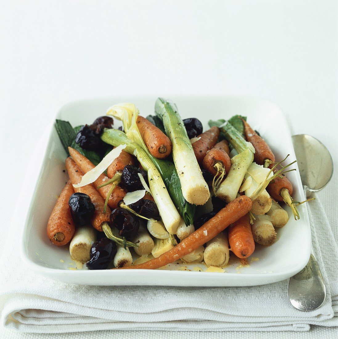 Roasted vegetables (leeks, carrots, olives) with cheese shavings