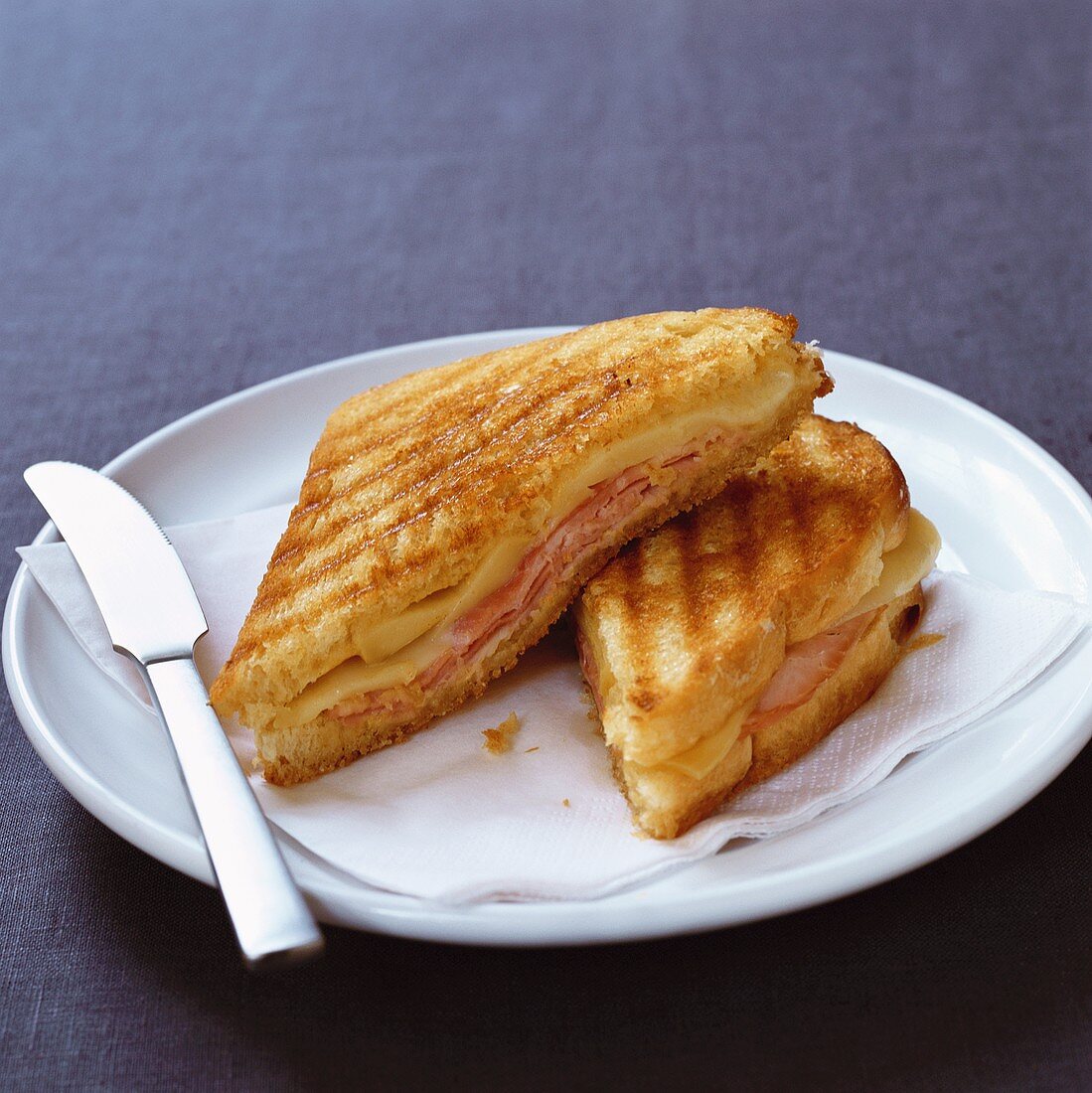 Toasted ham and cheese sandwich, halved