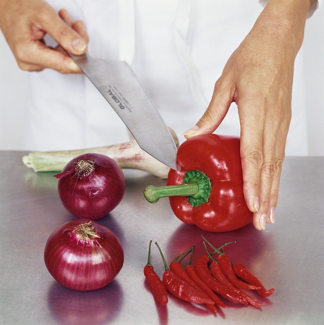 Cutting into a red pepper