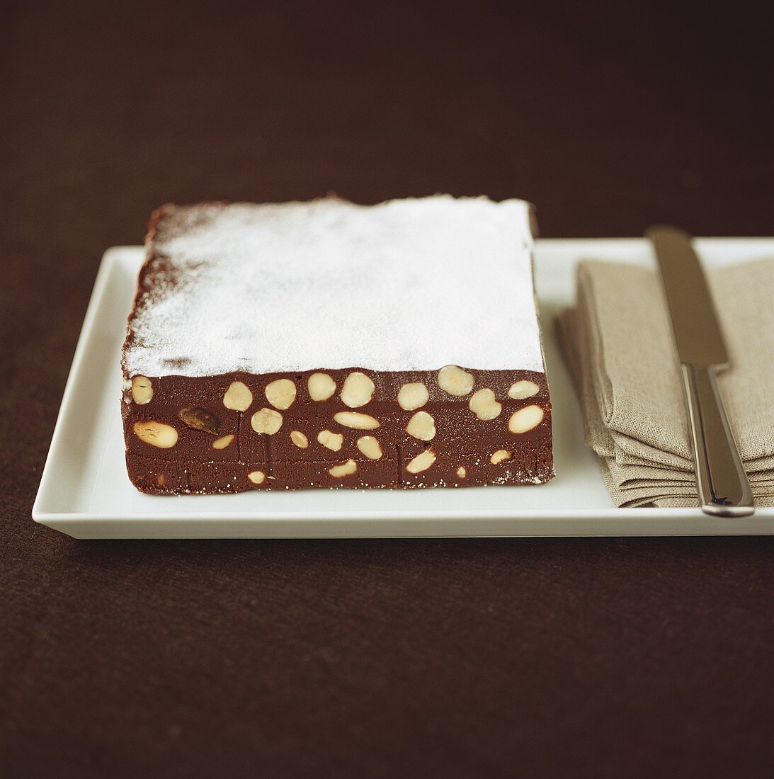 Chocolate nut cake with icing sugar