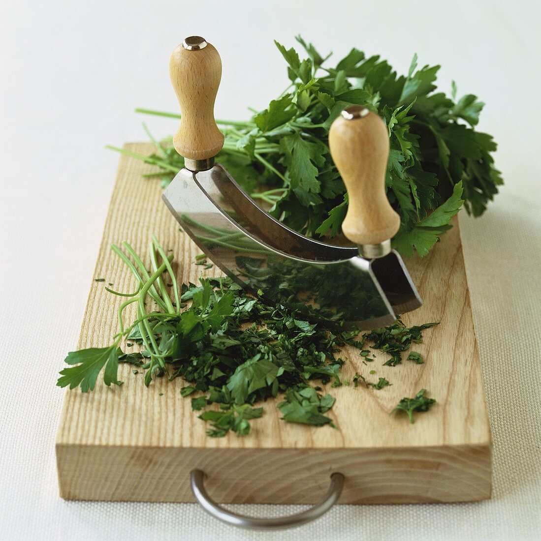 Parsley, partly chopped, with mezzaluna