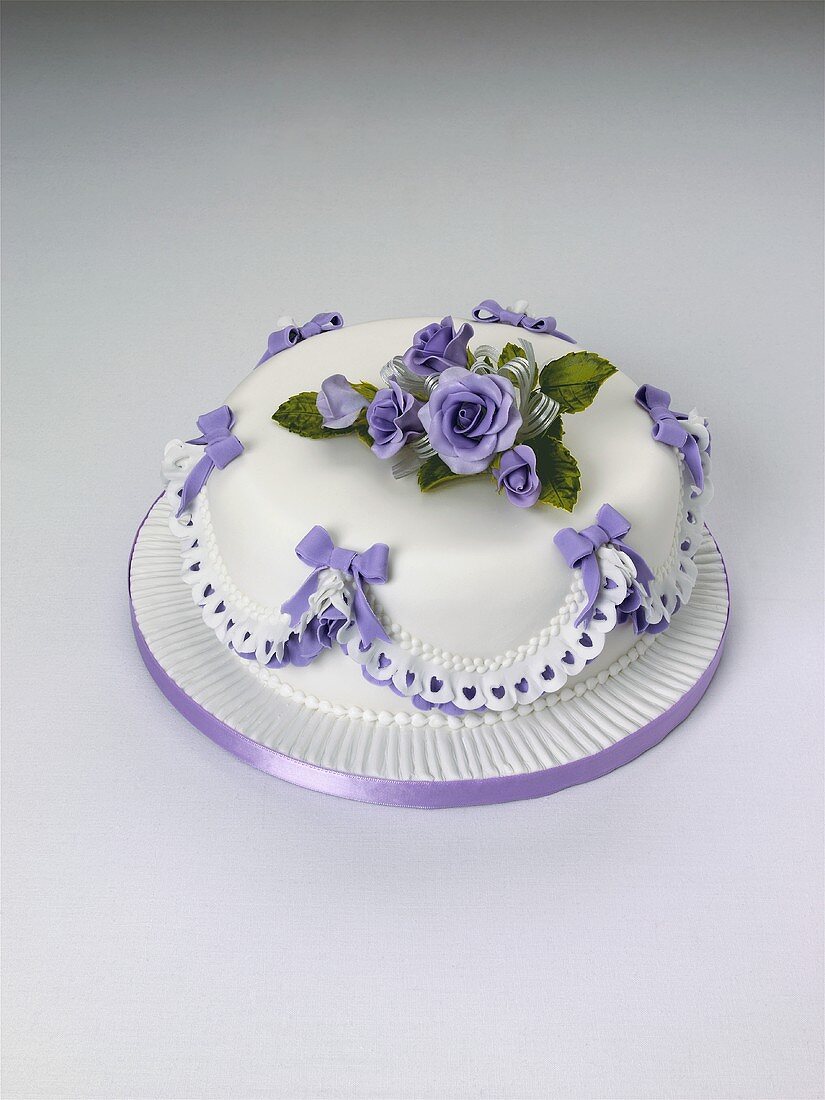 Cake with blue roses and bows for special occasion