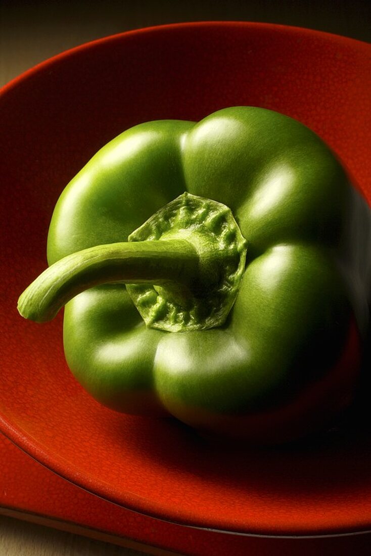 Green pepper in a red bowl
