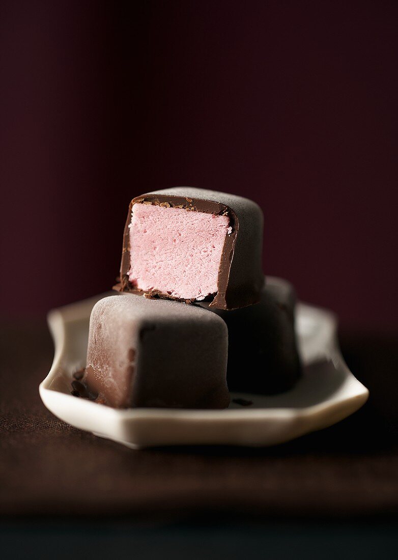 Raspberry ice cream chocolates on plate