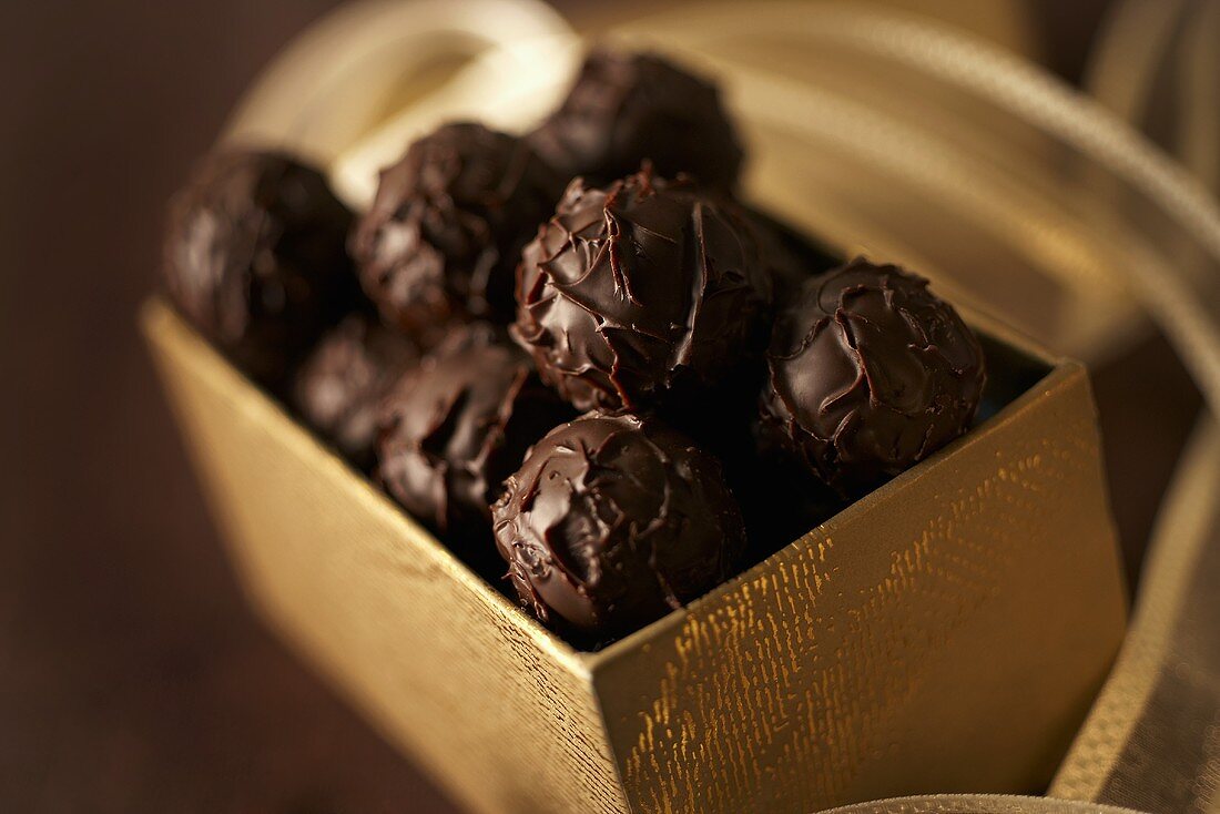 Chocolate truffles in gold-coloured box