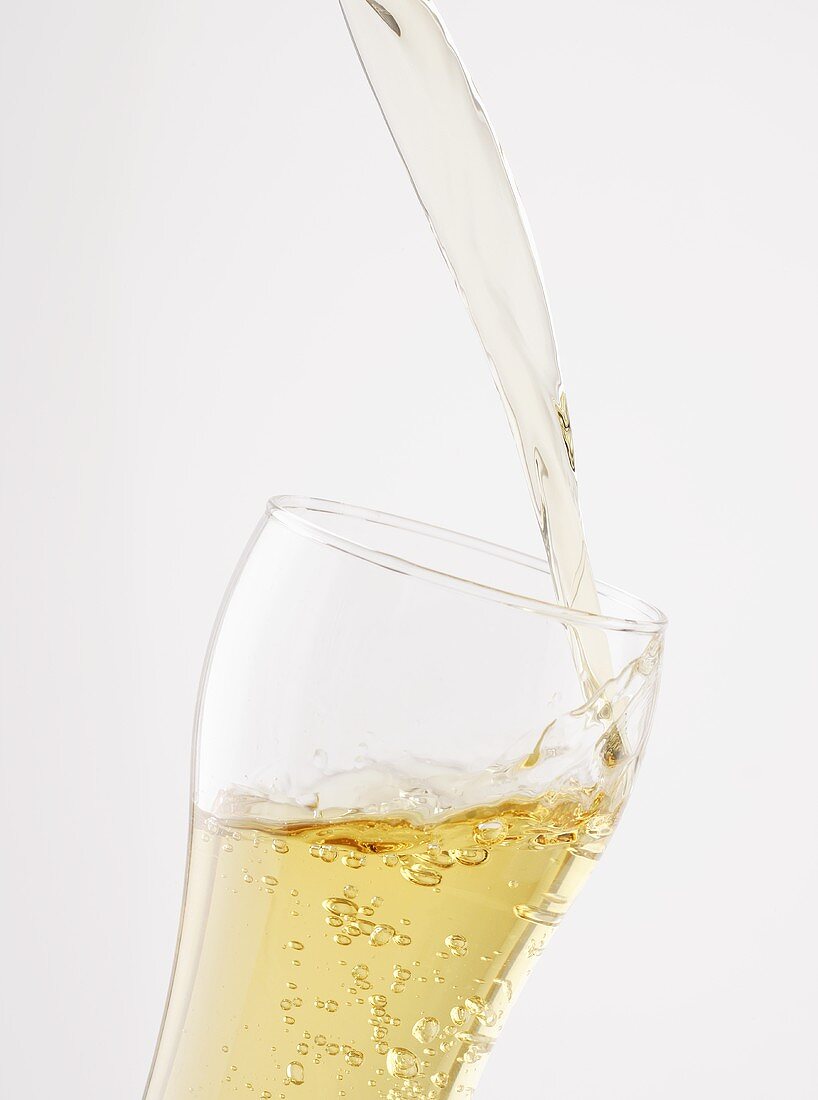 Pouring Apfelschorle (apple juice & carbonated mineral water)
