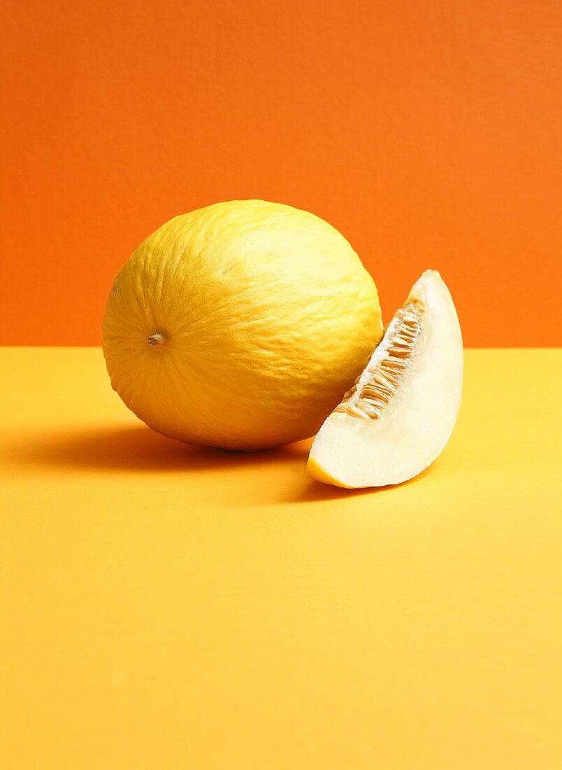 Honeydew melon on coloured background