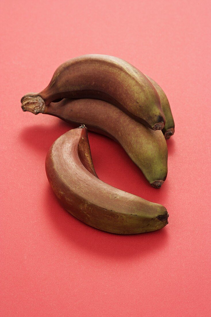 Red bananas on red background