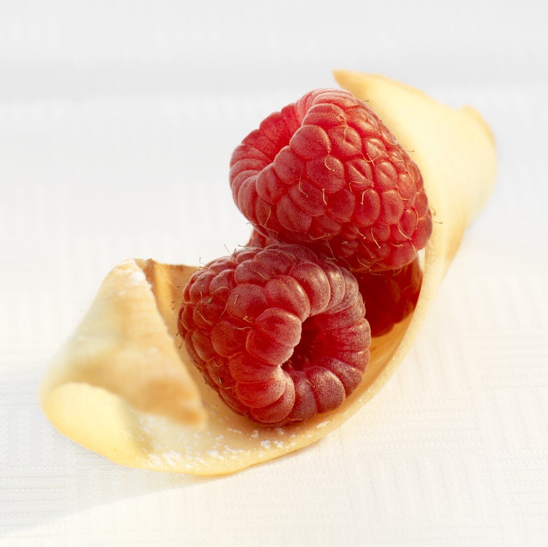 Two raspberries on wafer (close-up)