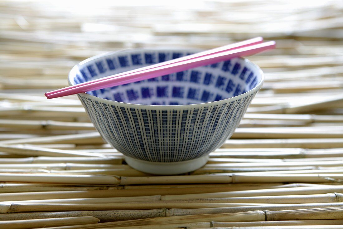 Empty Asian rice bowl with chopsticks