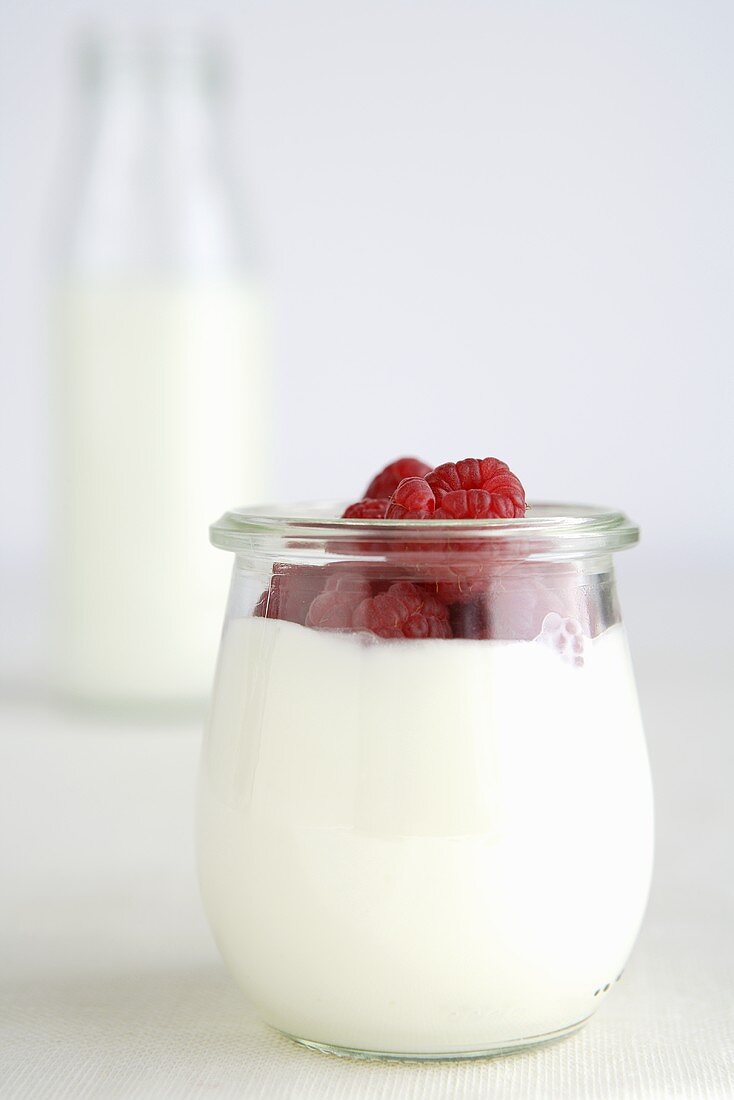 Yoghurt with raspberries in a jar