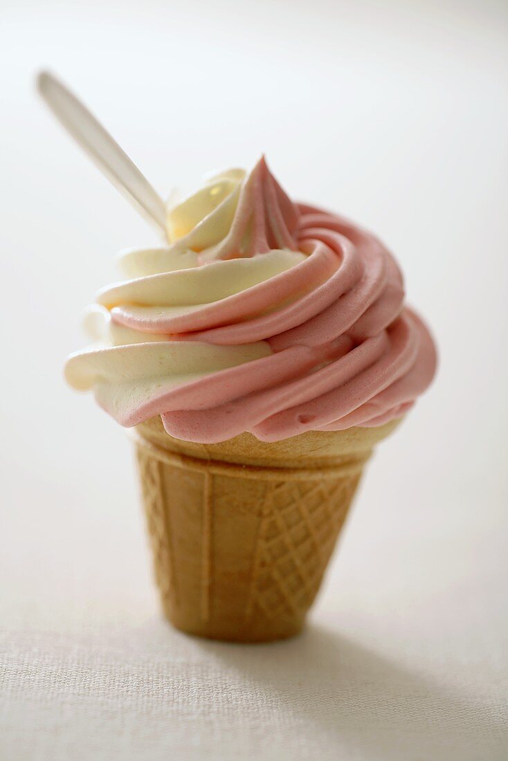 Strawberry and vanilla soft ice cream in cone