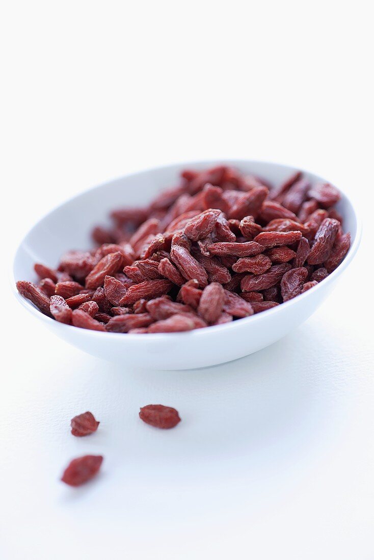 Dried goji berries in a white bowl