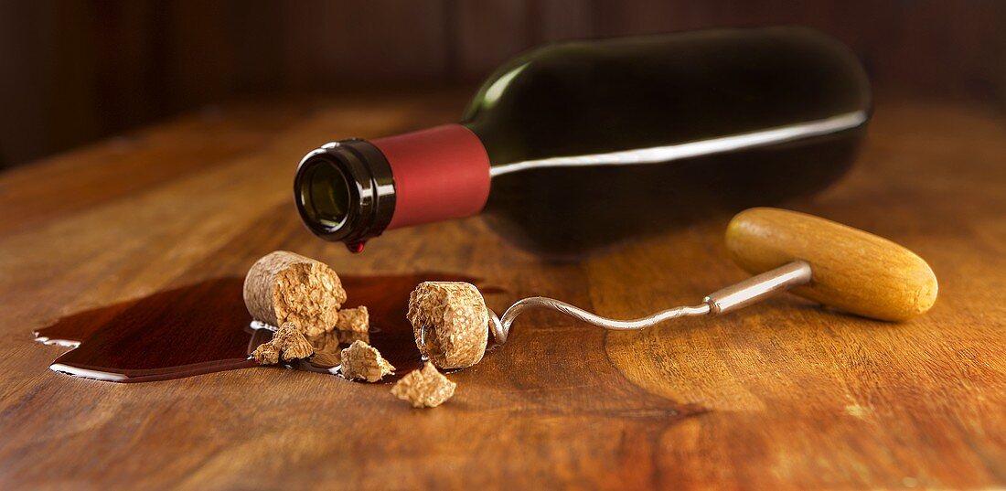 Red wine bottle, broken cork and corkscrew