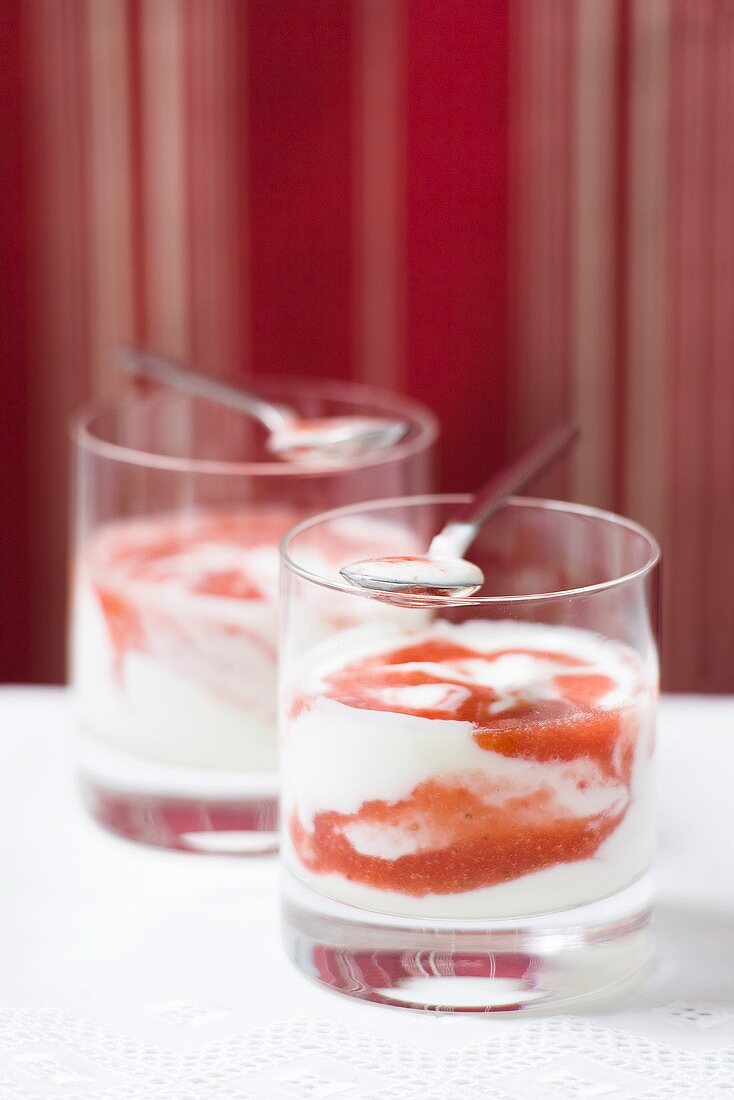 Two glasses of yoghurt with puréed strawberries