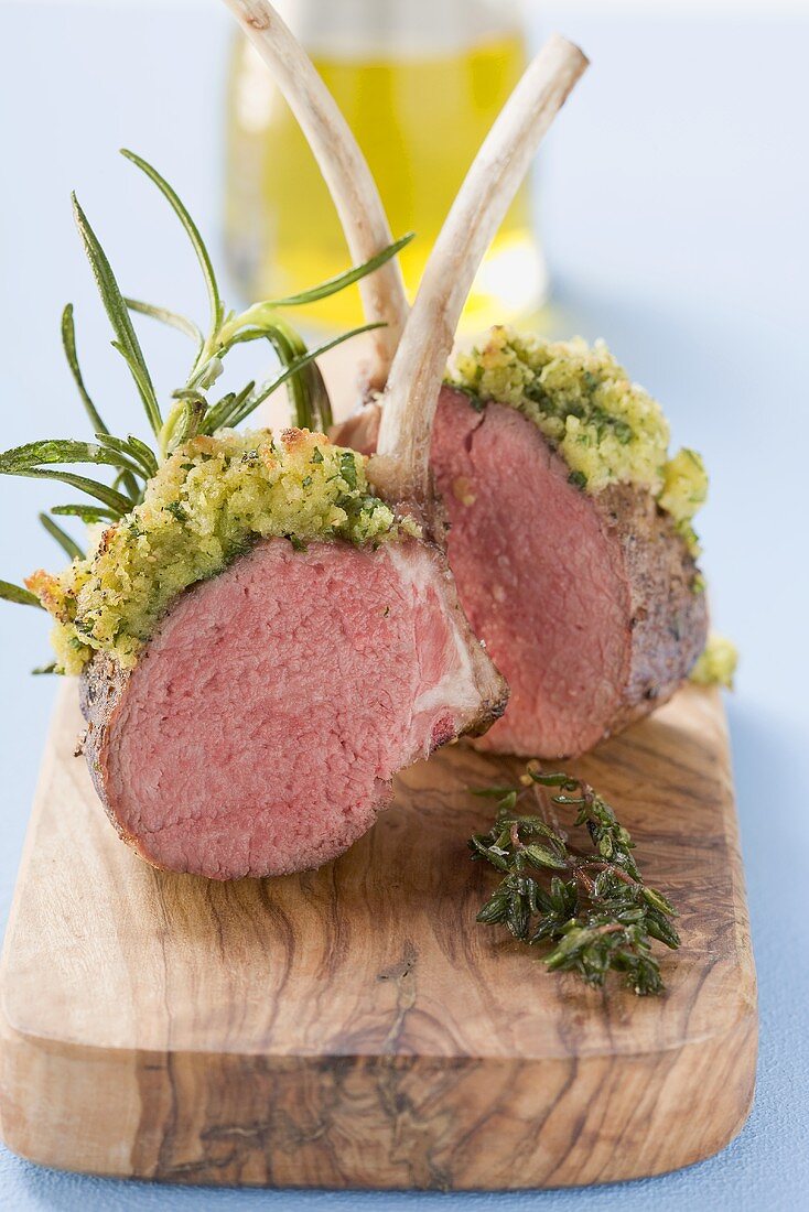 Lamb chops with herb crust on chopping board