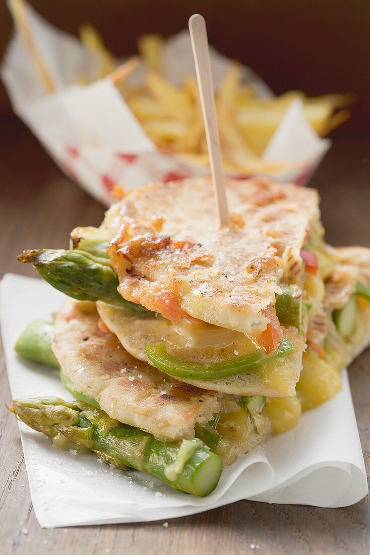Grilled pita bread filled with asparagus and cheese, chips