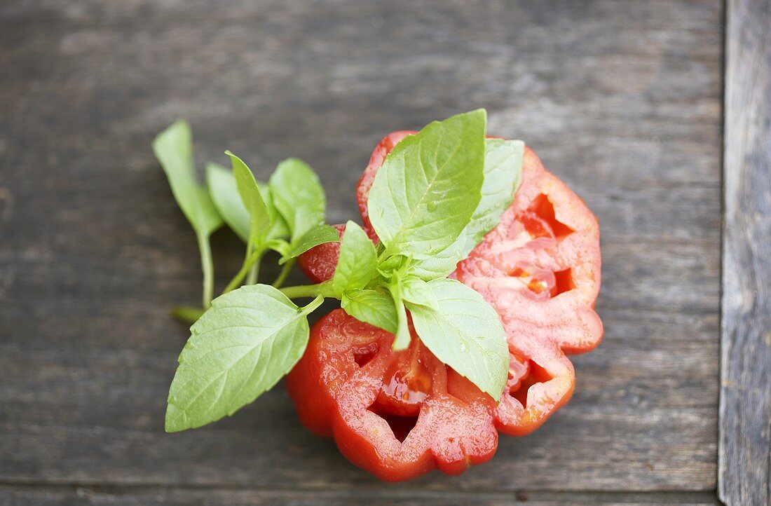 Slice of tomato and a sprig of basil