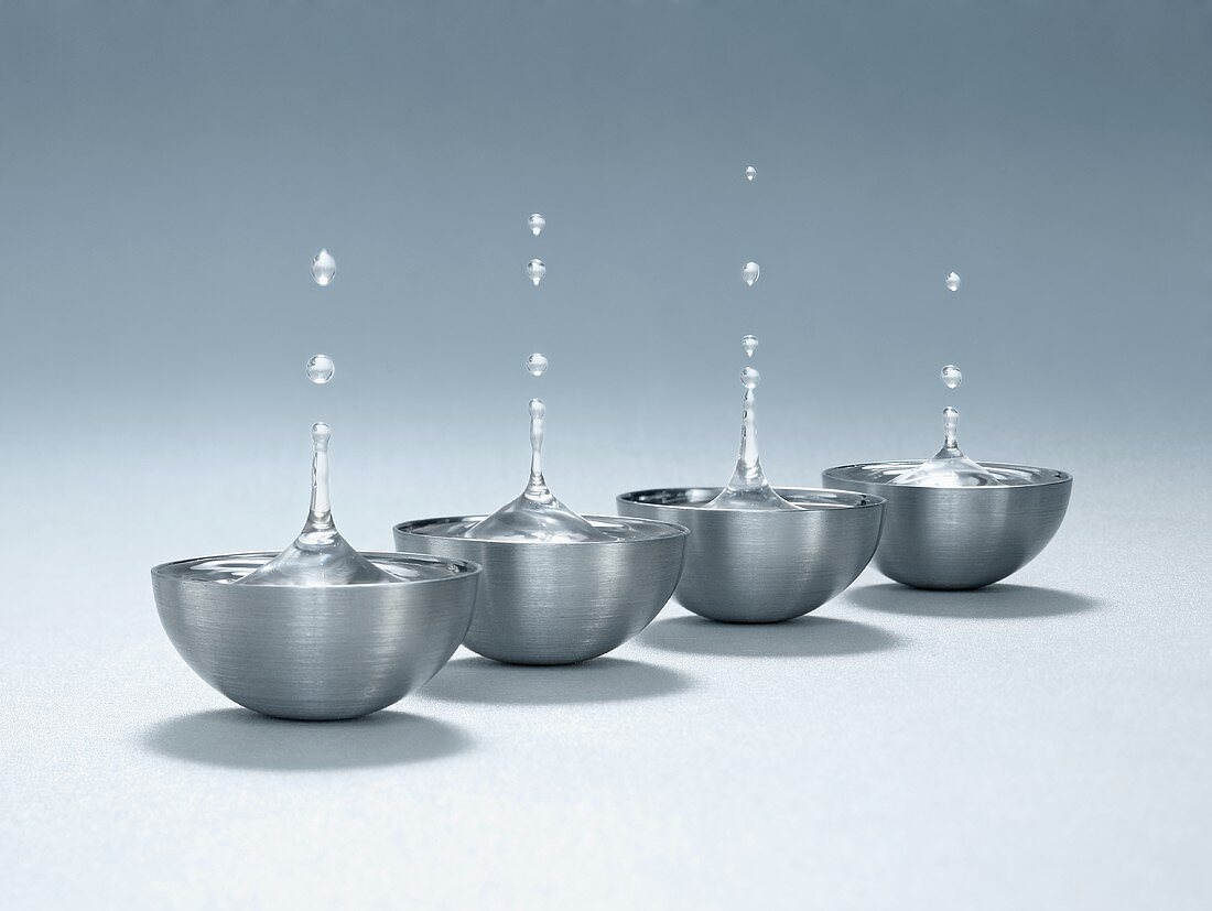 Drops of water over metal bowls