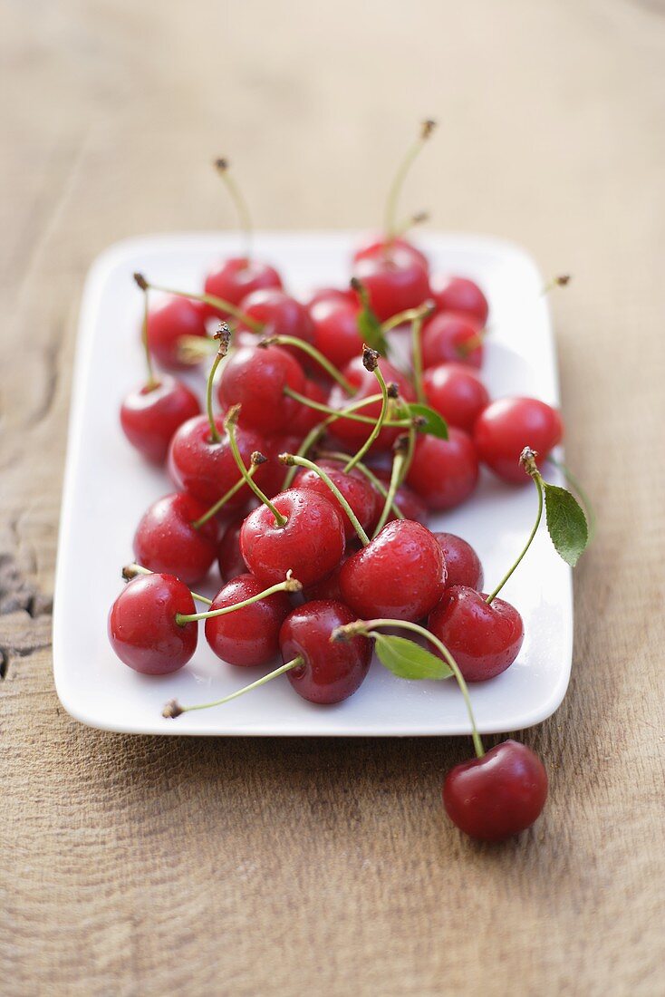 Sour cherries on white plate