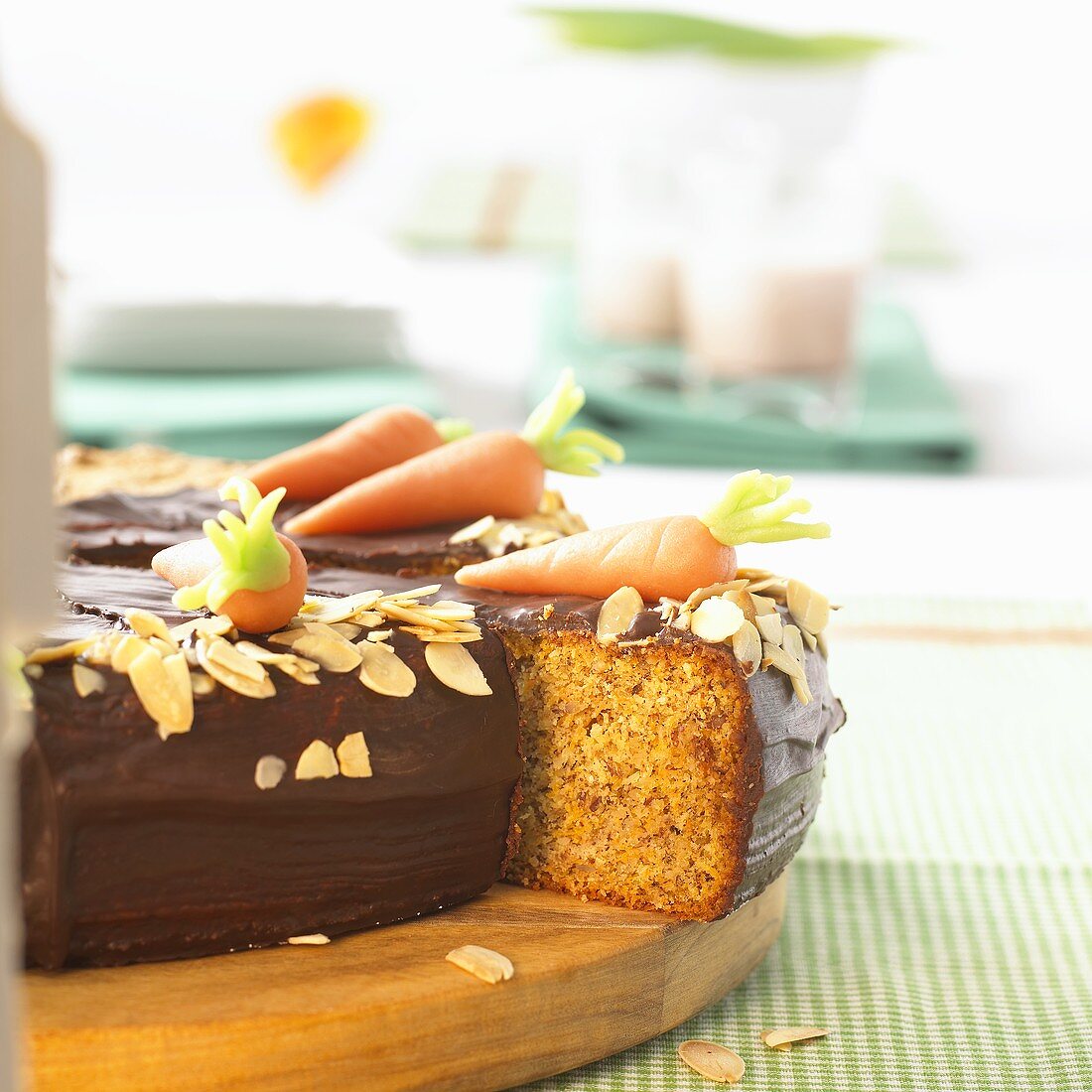 Carrot cake with marzipan carrots, a piece partly removed