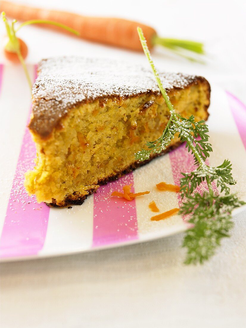 Piece of carrot cake with icing sugar