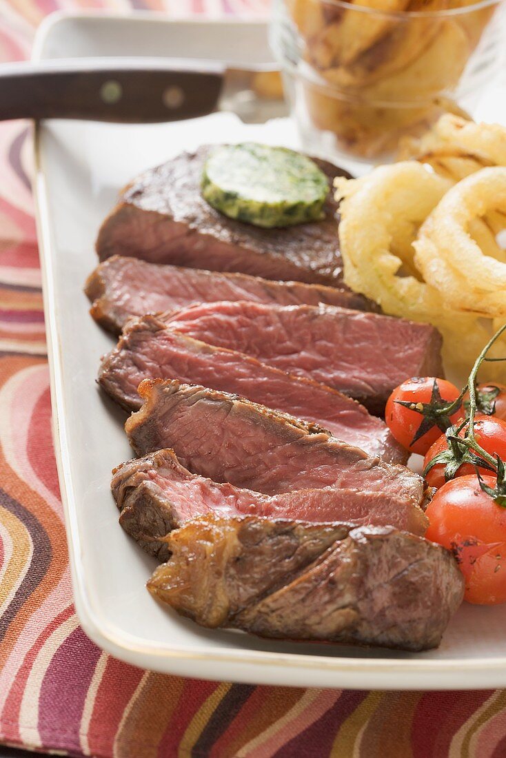 Beef steak with herb butter and deep-fried onion rings