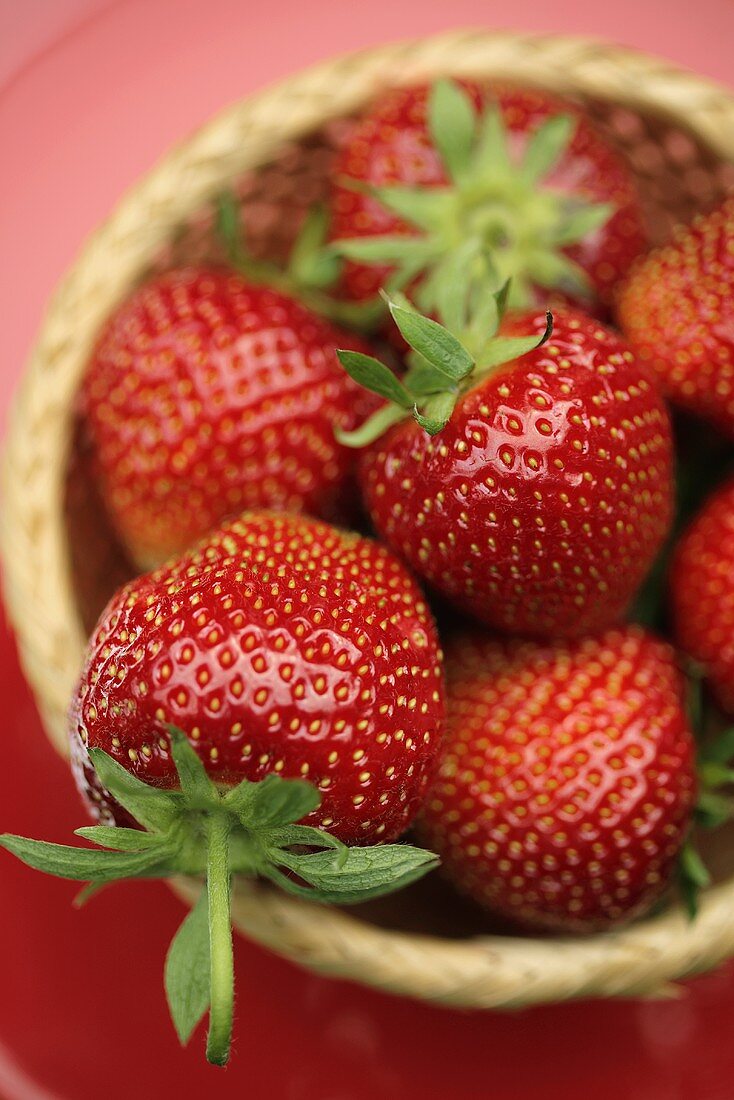 Fresh strawberries in a basket (overhead view)