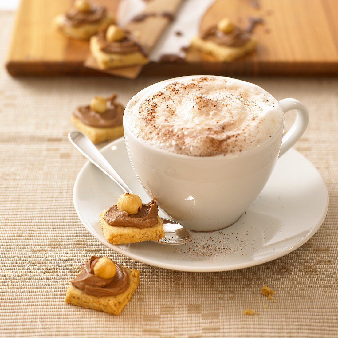 Cup of cappuccino and hazelnut biscuits