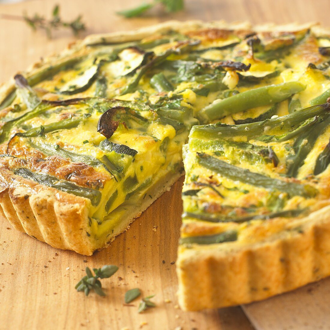 Green vegetable quiche with feta cheese, a piece cut
