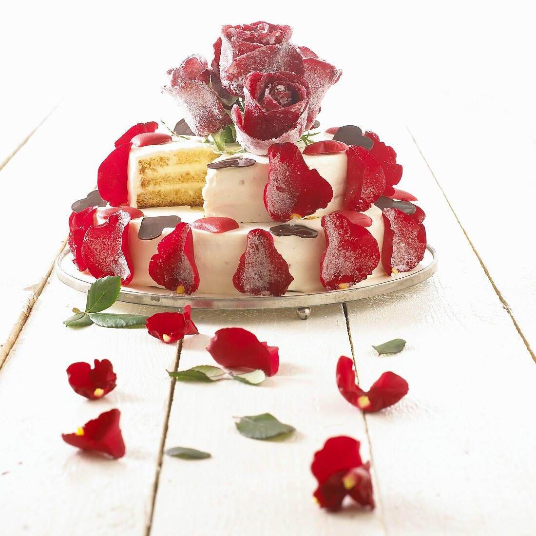 Wedding cake with red rose petals