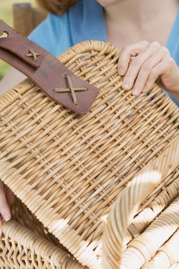 Woman opening a picnic basket