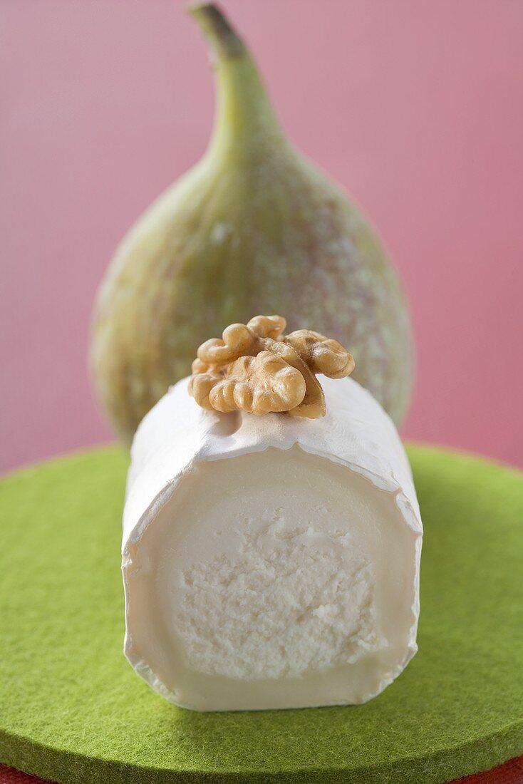 Goat's cheese with walnut, fig in background