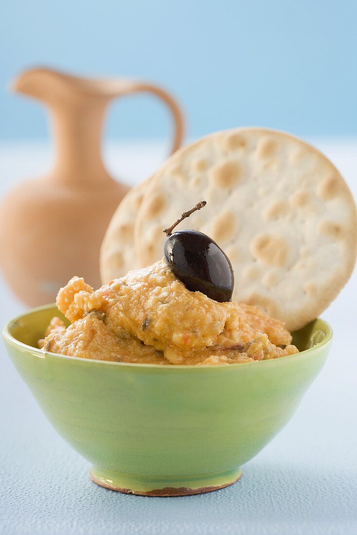 Sheep's cheese and pepper spread with olive and crackers