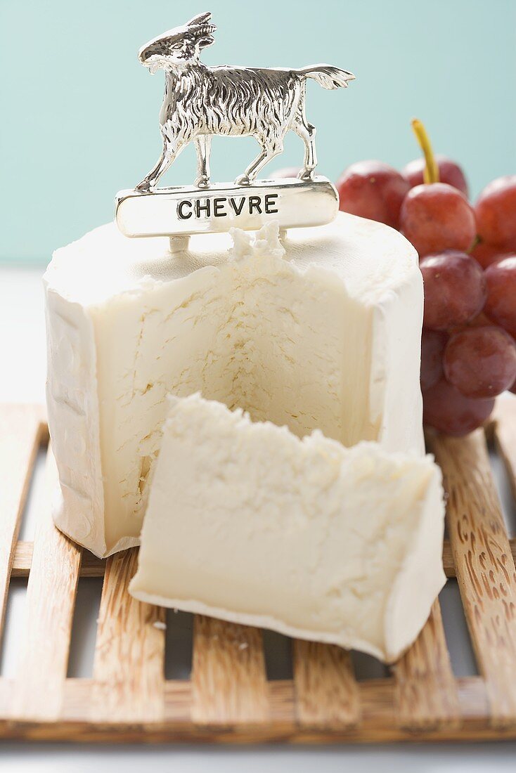 Chèvre (goat's cheese) with label, red grapes