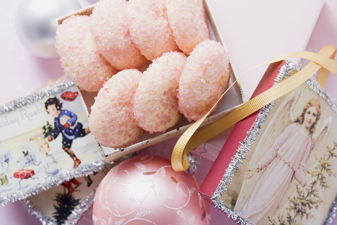 Pink sugar cookies surrounded by Christmas decorations