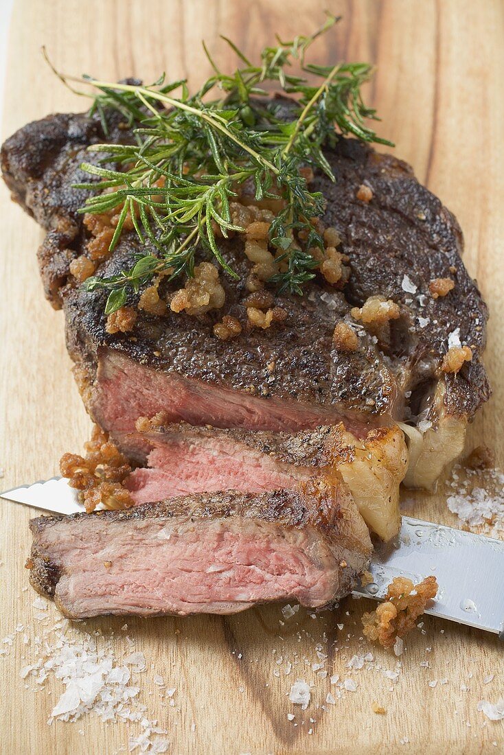 Fried steak with bacon and rosemary