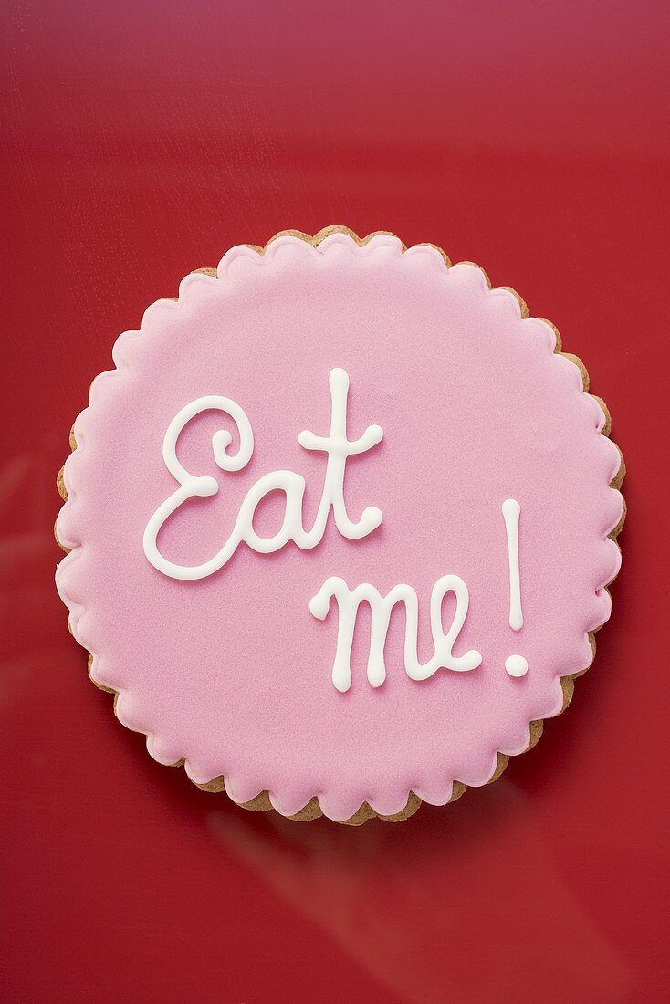 Pink biscuit with the words Eat me!