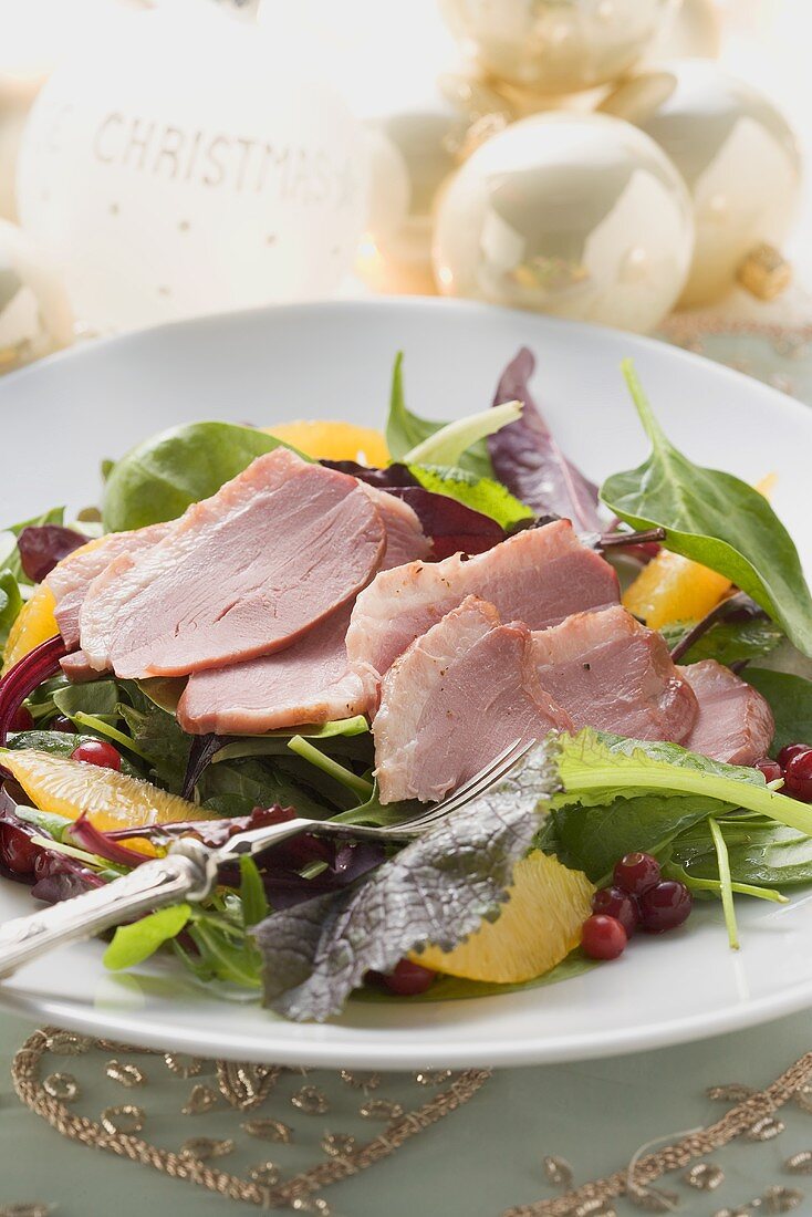 Salad leaves with smoked duck breast and orange segments