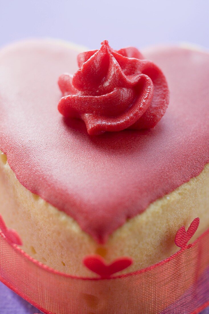 Small heart-shaped cake with pink icing