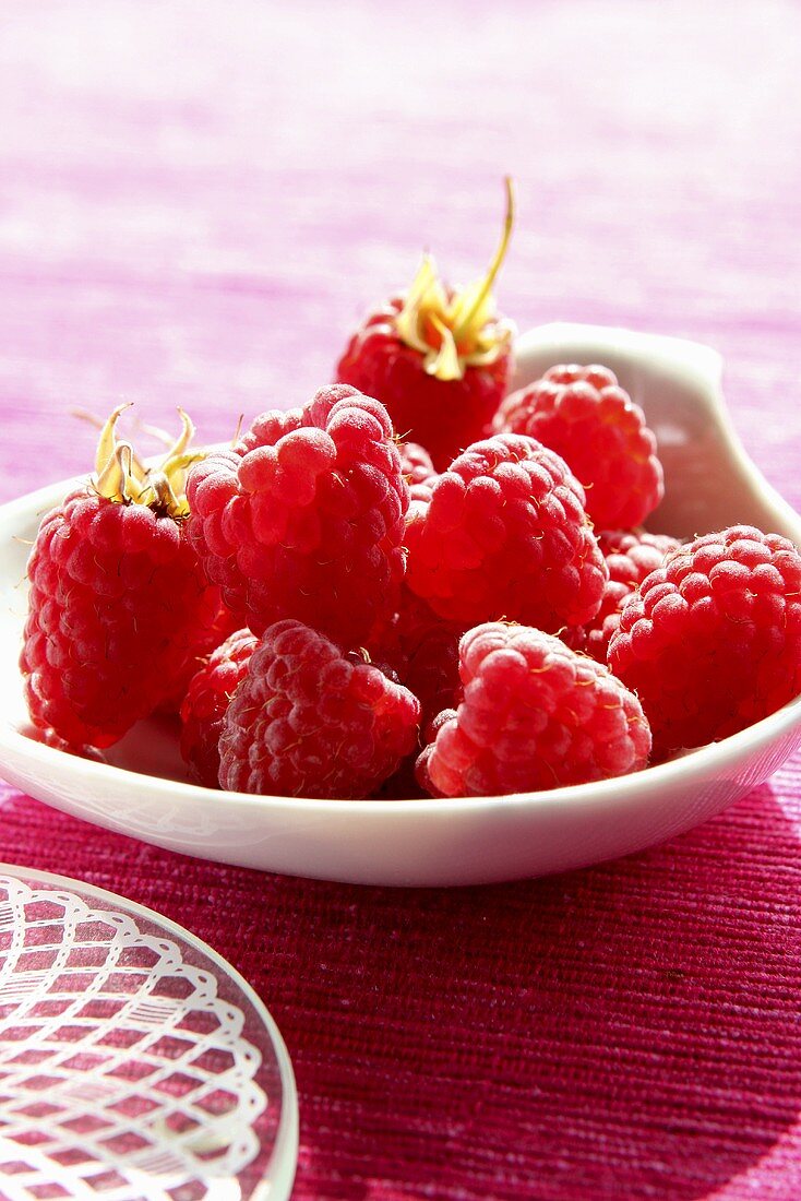 Raspberries in white dish