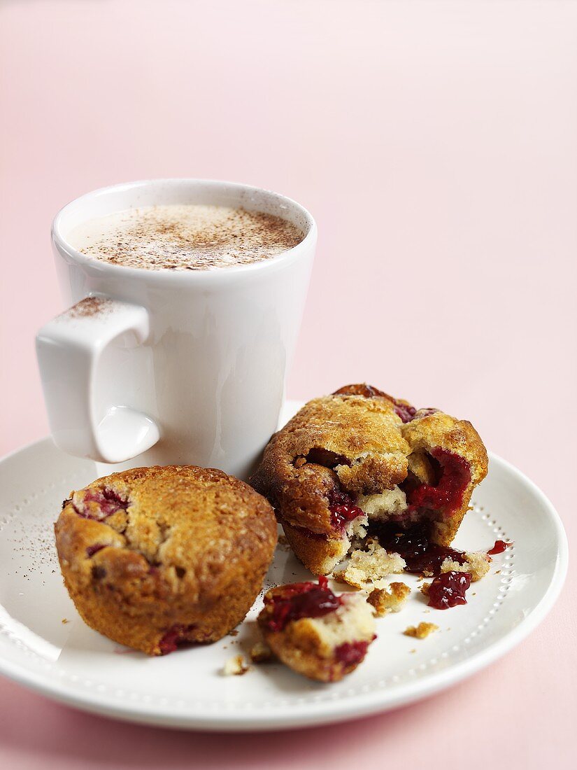 Raspberry muffins and cup of coffee