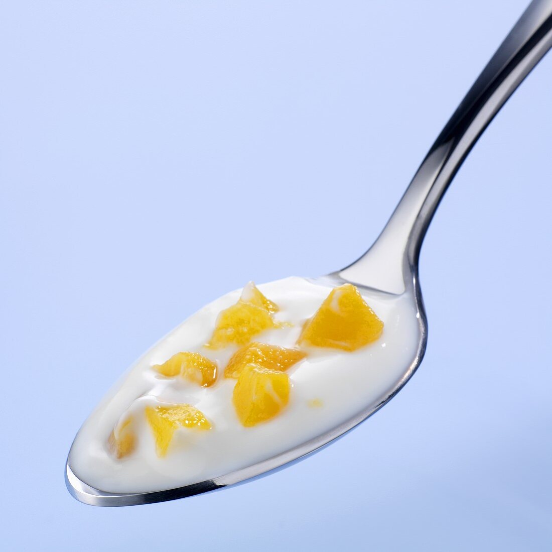 A spoonful of yoghurt with peach