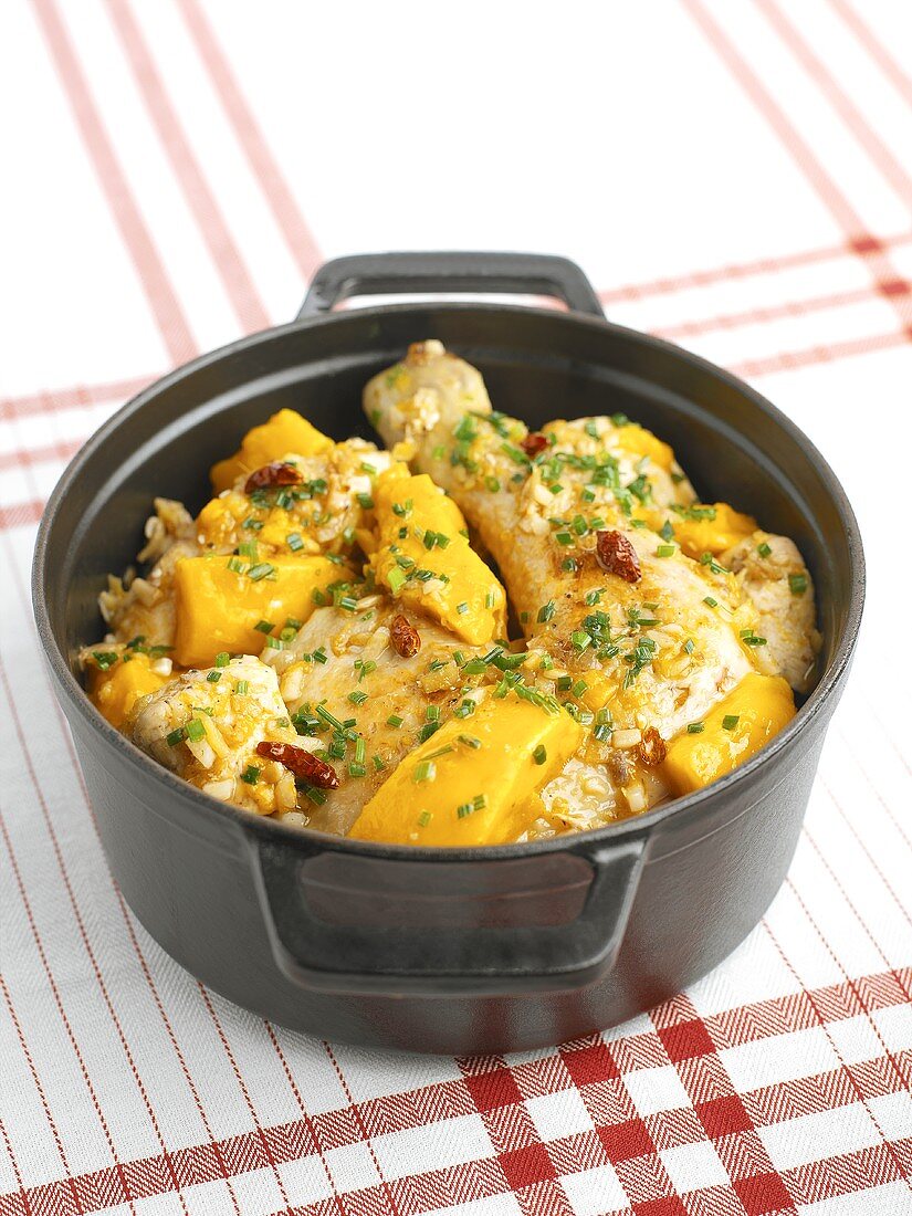 Chicken with mango in a cast-iron pot