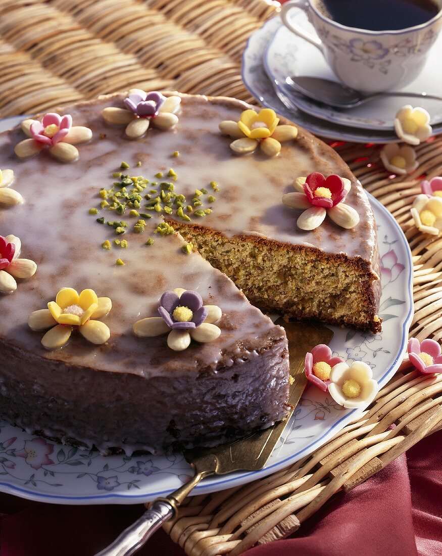 Almond cake with glacé icing and sugar flowers