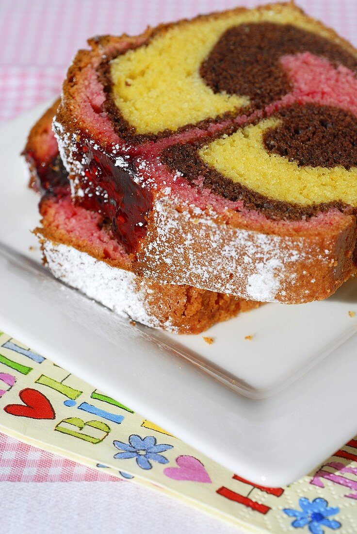 Two slices of three-coloured marble cake for child's birthday