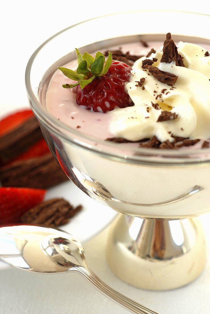 Strawberry sundae with cream and chocolate shavings