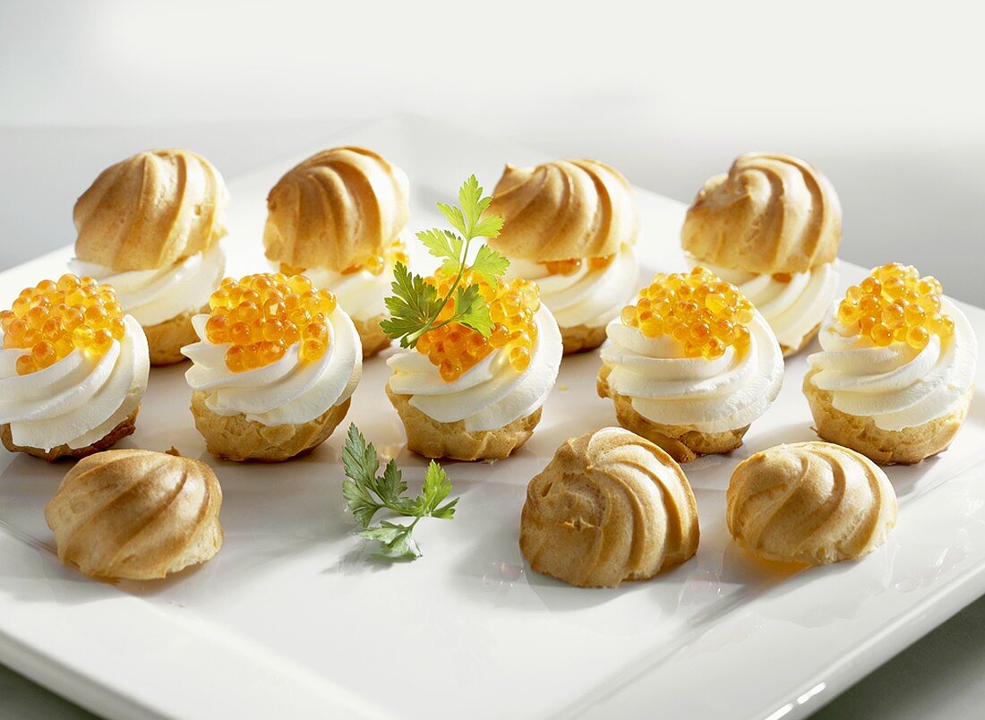 Profiteroles filled with soft cheese and trout caviar